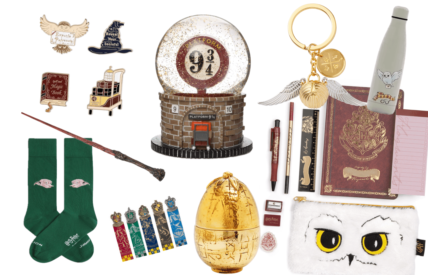 Small Harry Potter gifts: enamel pins, a Platform 9 3/4 snow globe, green socks, bookmarks, a wand, a keyring, stationery and a golden egg